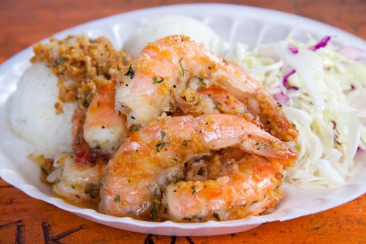 A nice plate of shrimp, rice and pineapple or garlic with rice and coleslaw in Hawaii.