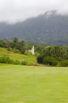 A great tropical golf course on oahu hawaii in the middle of a rainforest with magnificent greens and well manicured fairways.