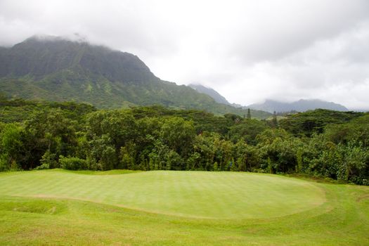 A great tropical golf course on oahu hawaii in the middle of a rainforest with magnificent greens and well manicured fairways.