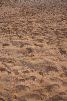 An abstract image of many foot prints in the tropical sand of the hawaii paradise.