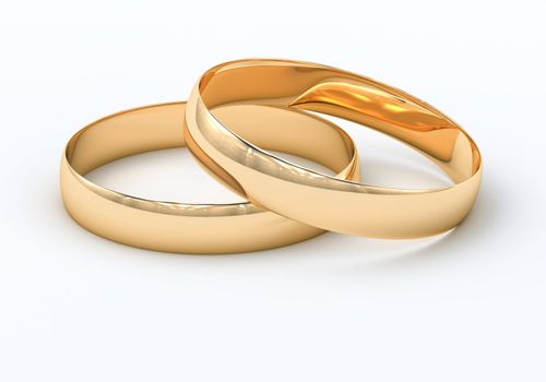 Wedding rings on a light background with reflections