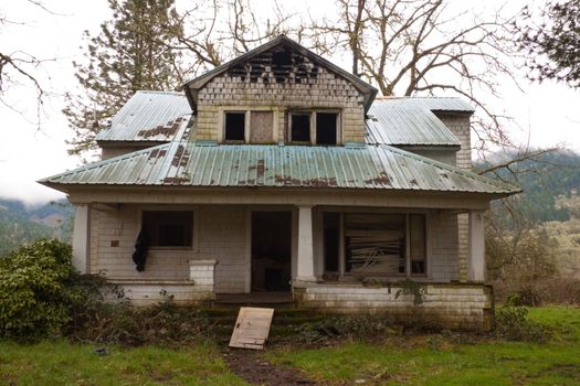 An old ranch home has been burned and abandoned.