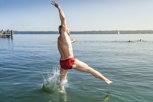 An image of a man jumping into the water