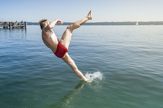 An image of a man jumping into the water