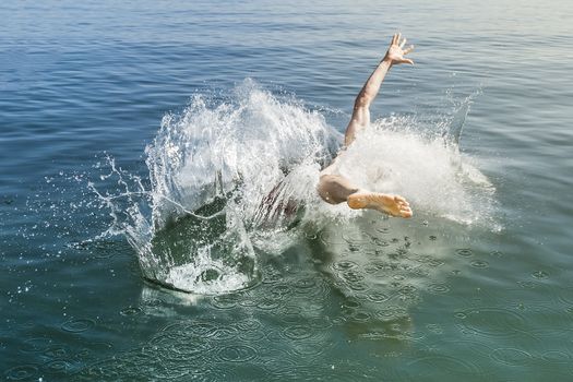 An image of a man jumping into the water