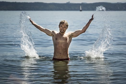 An image of a handsome man having fun in the water