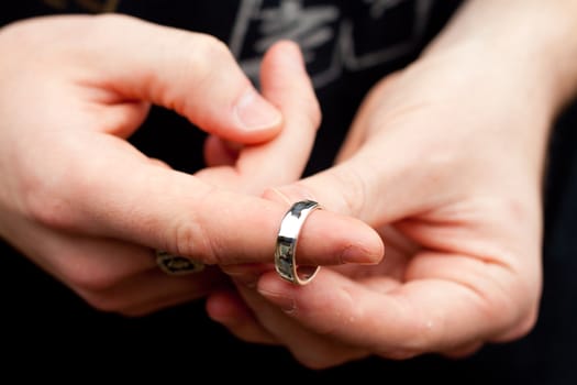 A man holds his wedding band before a wedding ceremony.