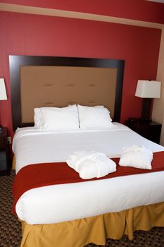 A nice hotel bed is made up and ready for inviting sleep in a suite.