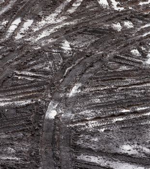 Wheel track in countryside road. Tire tracks in the mud