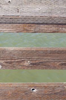 The railing of a pier is photographed in an abstract way to create some interesting texture images of wood and water.
