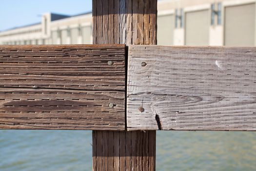 The railing of a pier is photographed in an abstract way to create some interesting texture images of wood and water.