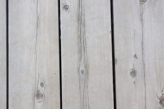 A very old section of a dock at Lake Tahoe showing the wooden planks and boards that make up the structure.