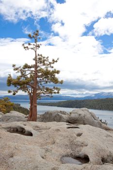 Views of Lake Tahoe in California with crystal clear water, snow on the ground, and mountains in the background.