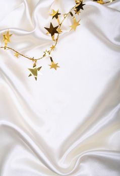 Golden stars and spangles on white silk