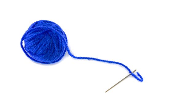 ball of blue wool and metal needle