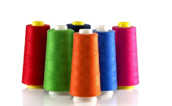 orange red blue green and pink bobbin isoalted on white