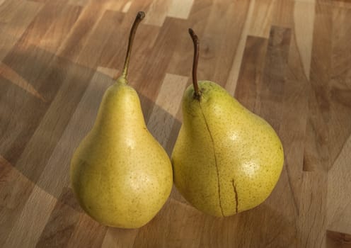 Fresh organic pears closeup on wooden board background