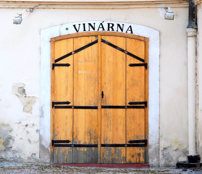 Shabby wooden door of an old Prague wine-house