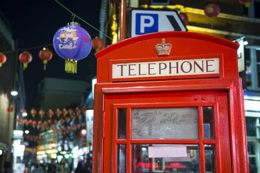 LONDON, UK - NOVEMBER 05: Detail of traditional red phone booth in Chinatown, the main Chinese commercial district in the city. November 05, 2012 in London.