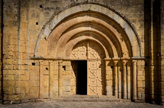 Stone church entrance door and arcs, St Emilion, France