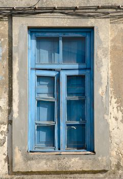A closed old window with dirty glass.