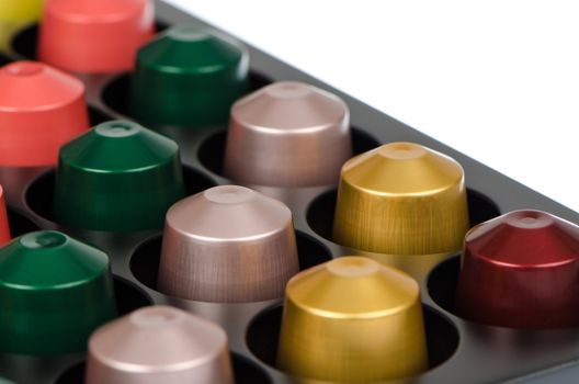 Coffee capsules for a coffee machine, close up view isolated on white background.