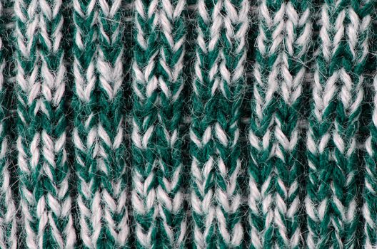 Knit woolen texture. Fabric green and white background.