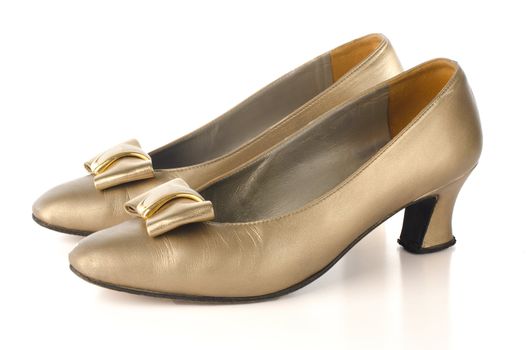 Gold high-heeled shoes isolated on white background.