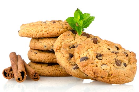 Fresh and tasty oat biscuits with cinnamon sticks on white background.