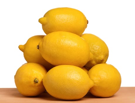 Pile of fresh ripe lemons on wooden table