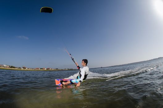 Kiteboarder enjoy surfing on a sunny day.