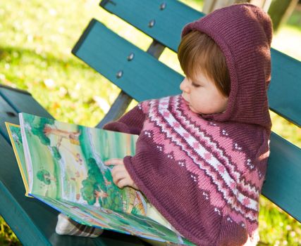 little girl reading a book