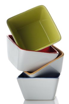 Colorful bowls stacked one above the other on white background.