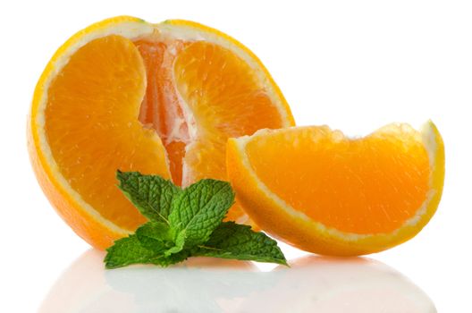 Orange fruit segment and mint leaf on white background.