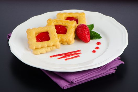 Belgium waffles with strawberries on plate.