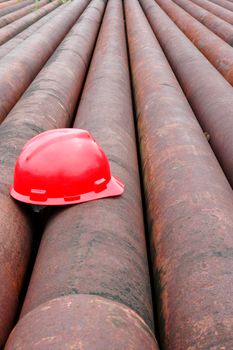 red helmet miner oil on an iron pipe in an oil mining area