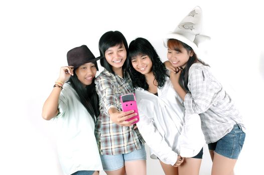 teenage girls take pictures with cell phone cameras photographed  in the  studio