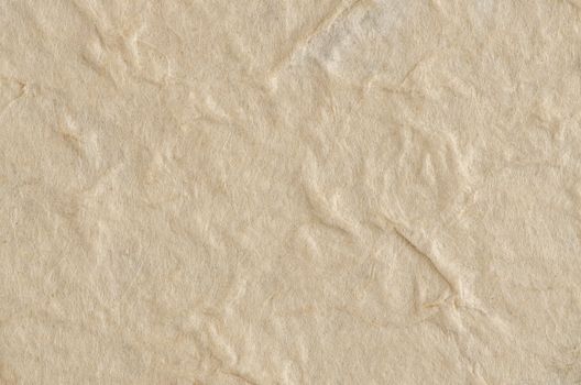 Cream textured paper closeup, can be used as a background.