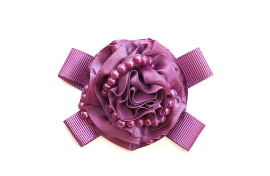 A purple decorative ribbon in form of rose