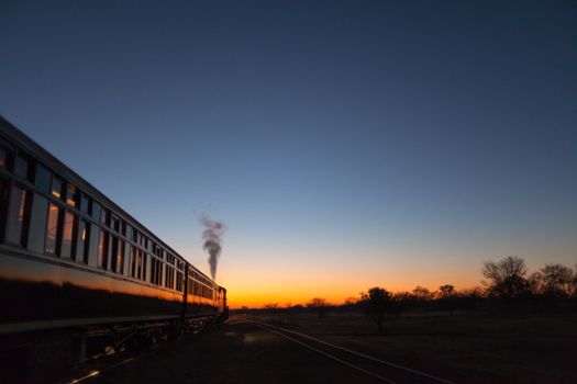 Vintage train going off into the sunset