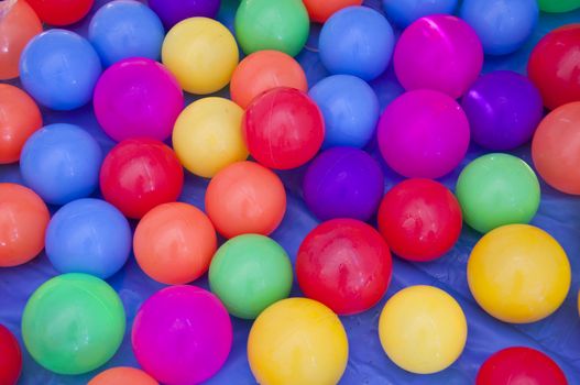 Toys for children with multi-colored plastic balls.