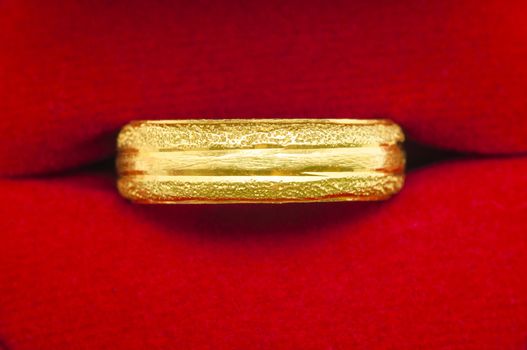 golden ring on red velvet background