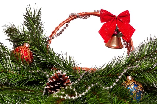 Christmas wicker basket with artificial green branch on white background