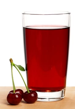 Sweet cherries and glass of juice on a white background