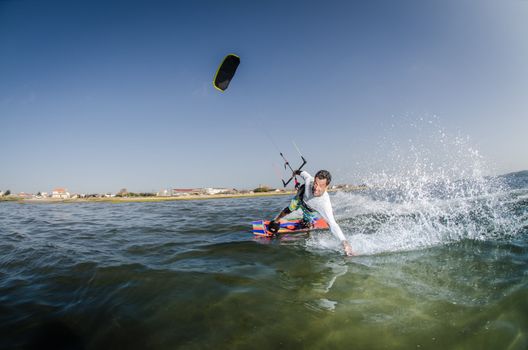 Kiteboarder enjoy surfing on a sunny day.