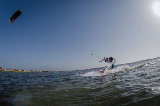 Kiteboarder enjoy surfing on a sunny day.