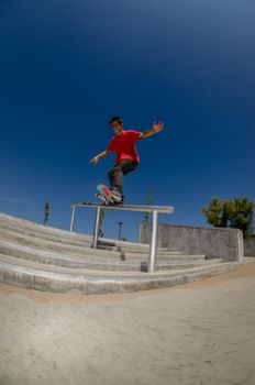 Skateboarder on a slide at the local skatepark.