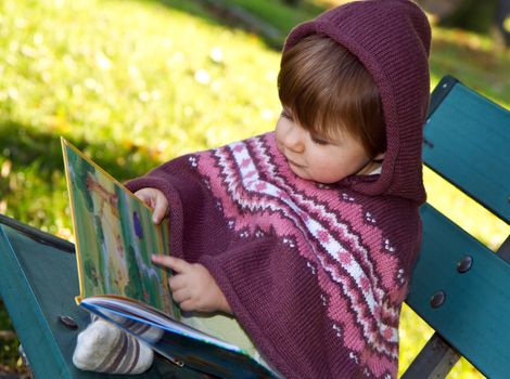 little girl reading a book