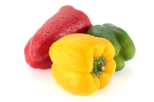 red green and yellow peppers on white background