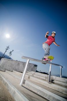 Skateboarder on a slide at the local skatepark.